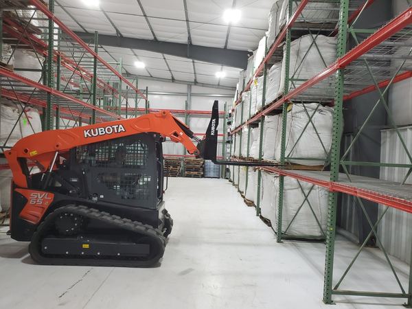 Track loader moving bulk bags in the biomass warehouse